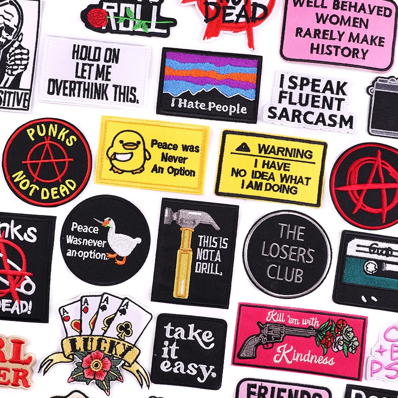 Collection of various patches with different designs and text on a white background
