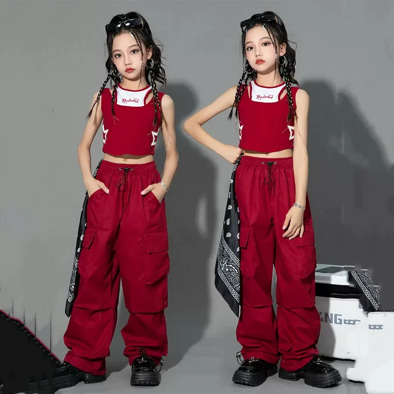 Teen girl posing in high-waisted cargo joggers with a vintage streetwear look, standing against a graffiti wall