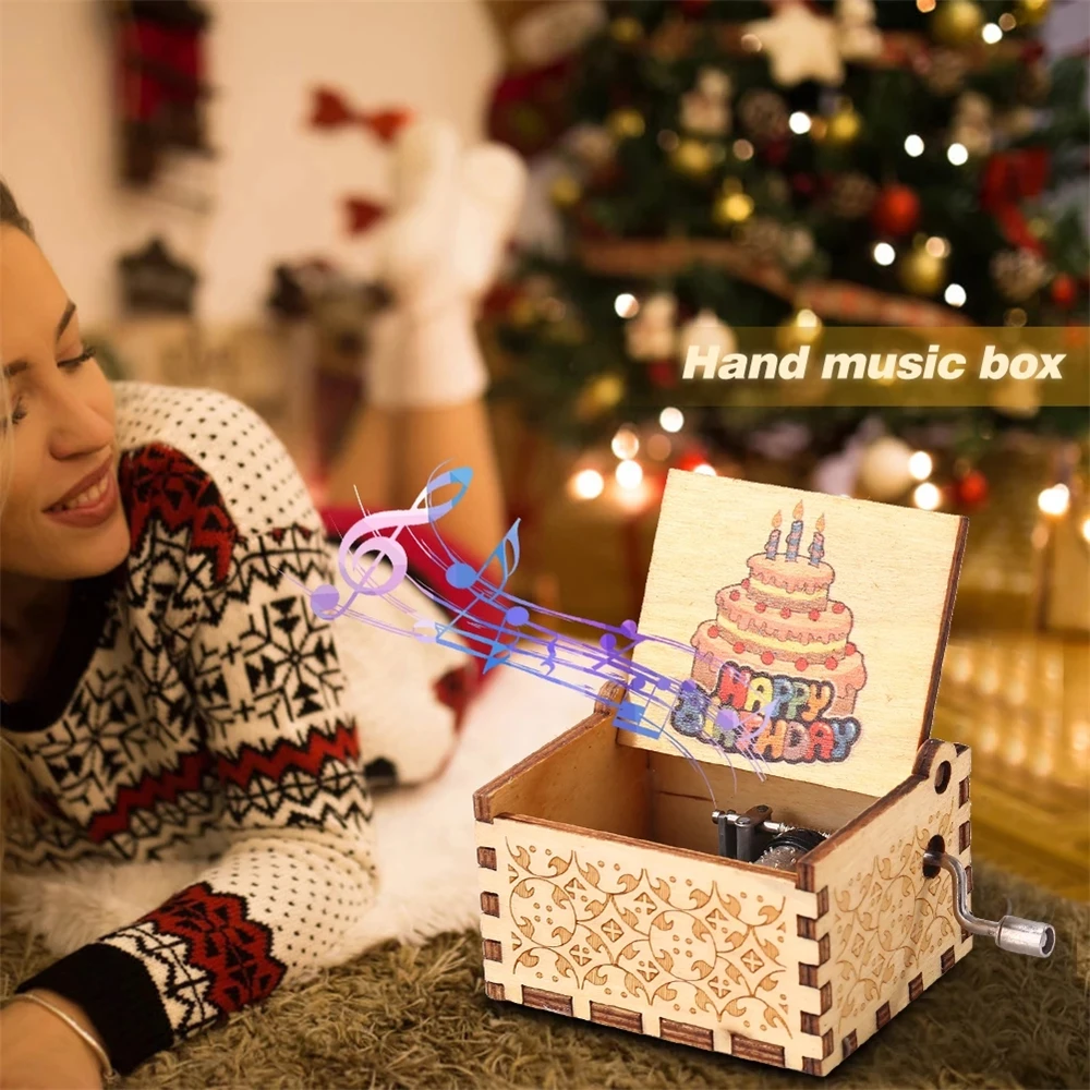 A woman in a decorated room smiles at the Happy Birthday Music Box, which features "Happy Birthday" and a cake illustration inside, with music notes illustrated coming out of the box.