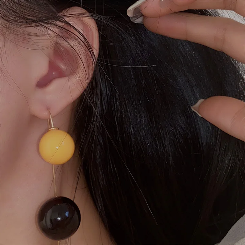 

Exaggerated personality and unique design yellow and black double ball earrings