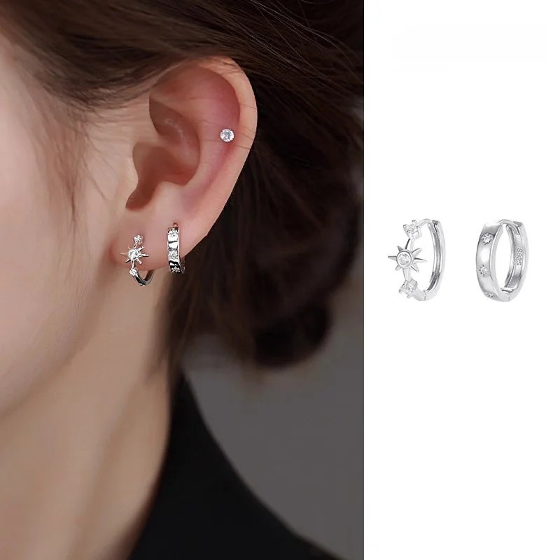 Asymmetric star shaped hoop earrings on display