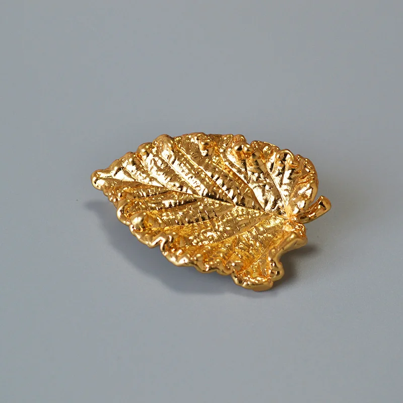 

In niche design, antique brass gilded irregular texture leaf shaped brooch and corsage accessories