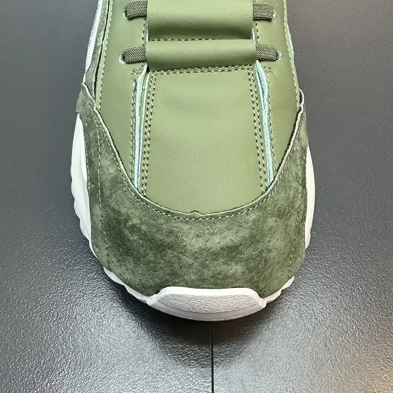 The front of a white and green summer sneakers