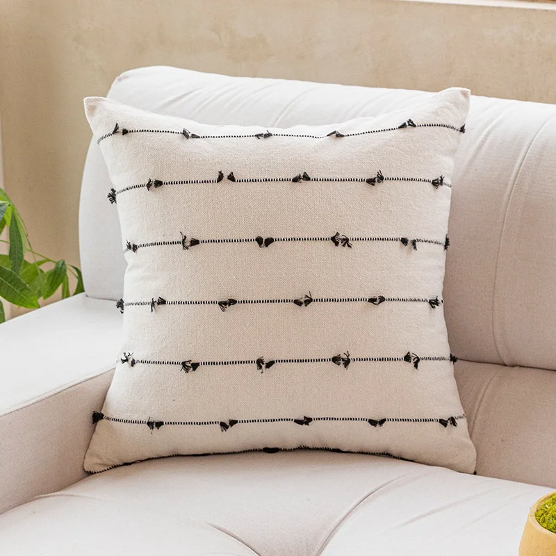 Black striped jacquard pillow cover on a sofa