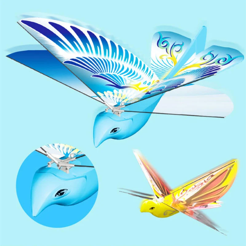 Drone jouet oiseau volant pour enfant posé sur une table, ailes déployées, lumières LED allumées