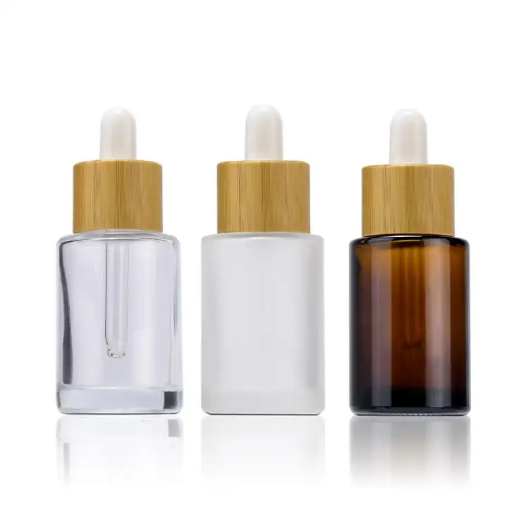 

Flat Shoulder Glass Essential Oil Perfume Bottles Transparent Amber Frosted 30ml 1oz Eye Dropper Bottle with Bamboo Cap SN1159