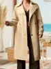 2978-85765c.jpg A woman wearing a elegant, belted plus size wool coat on a winter day.