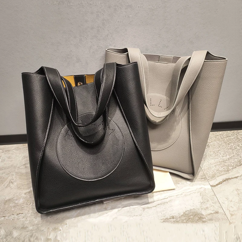 

Vintage hollow perforated lettering leather large capacity handbag Women's new shopping bag Fashion multi-functional bucket bag