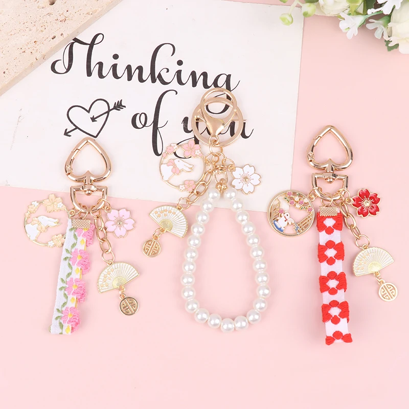 

Creative Sweet Cherry Blossom Rabbit Keychain For Women Webbing Pearl Key Chain Handbag Headphone Case Pendant Jewelry