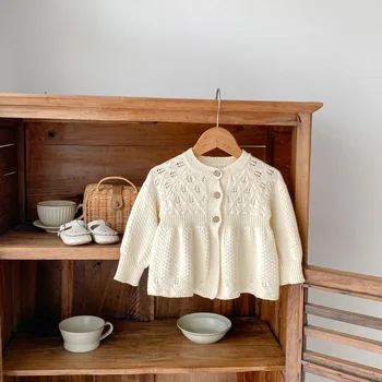 New autumn clothing for infants aged 0-3, sweaters for baby girls, hollow knitted cardigans, and A-line versatile jack