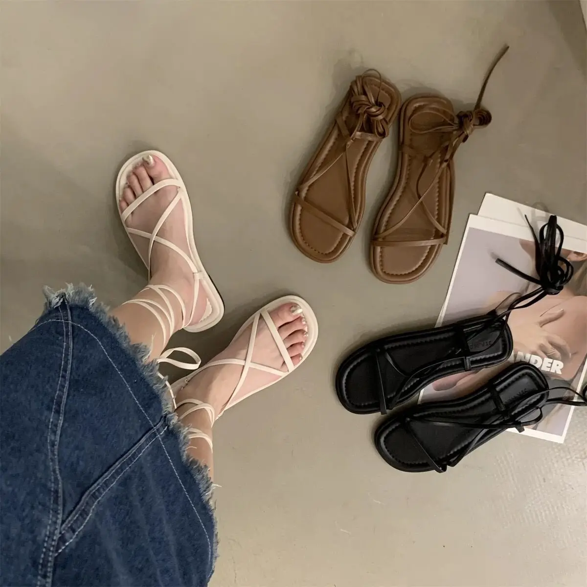 

Strap sandals women's summer flat bottom 2024 new Korean version retro fairy style simple open toe Roman shoes