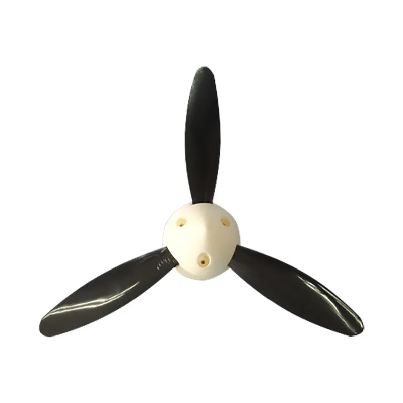 Spinner d'hélice RC 2 pouces 3 pales en nylon avec vis, posé sur une surface blanche avec reflets.