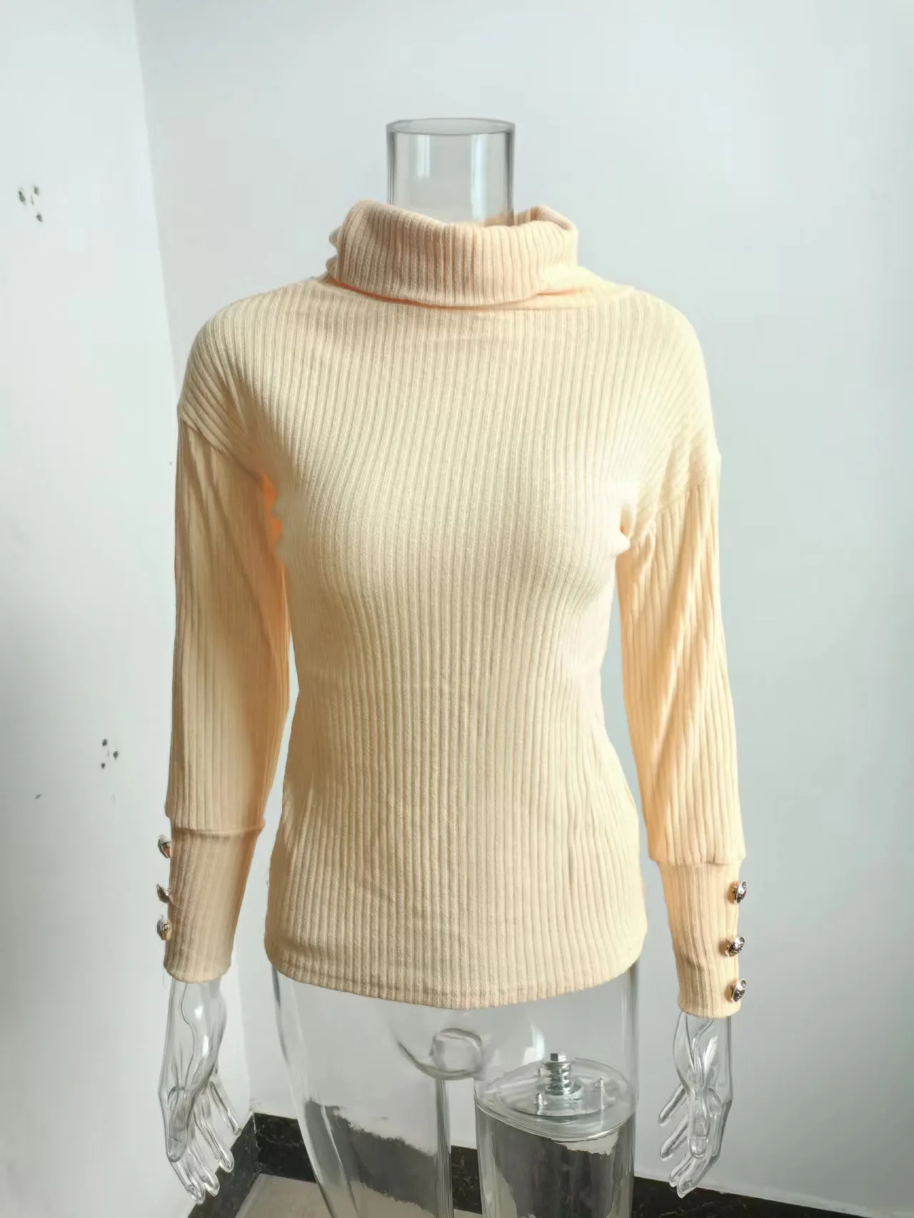 Close-up of Ribbed Knit Texture and Button Cuffs