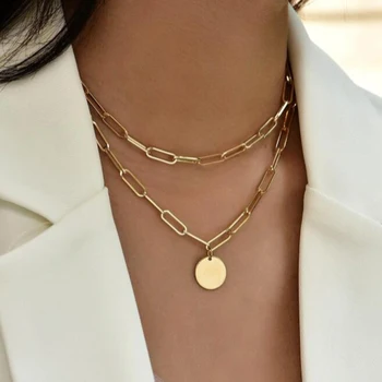 A woman donning a fashionable Charm Layered Necklace for Women with a disc pendant.