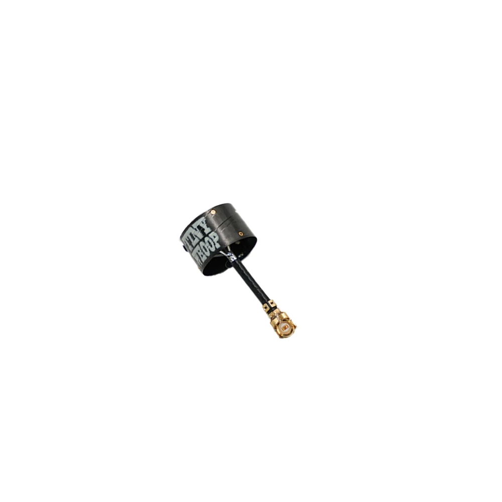 Antenne FPV Smol TrueRC 5.8GHz posée sur une pièce de monnaie pour illustrer sa légèreté.
