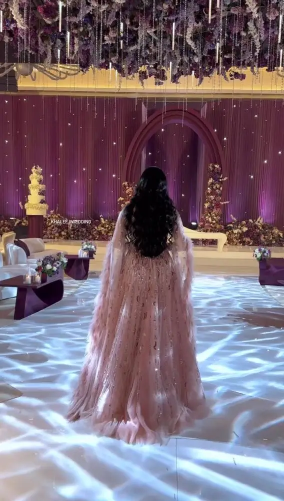 فستان سهرة من MisShow مخصص بالريش الوردي والخرز مع...