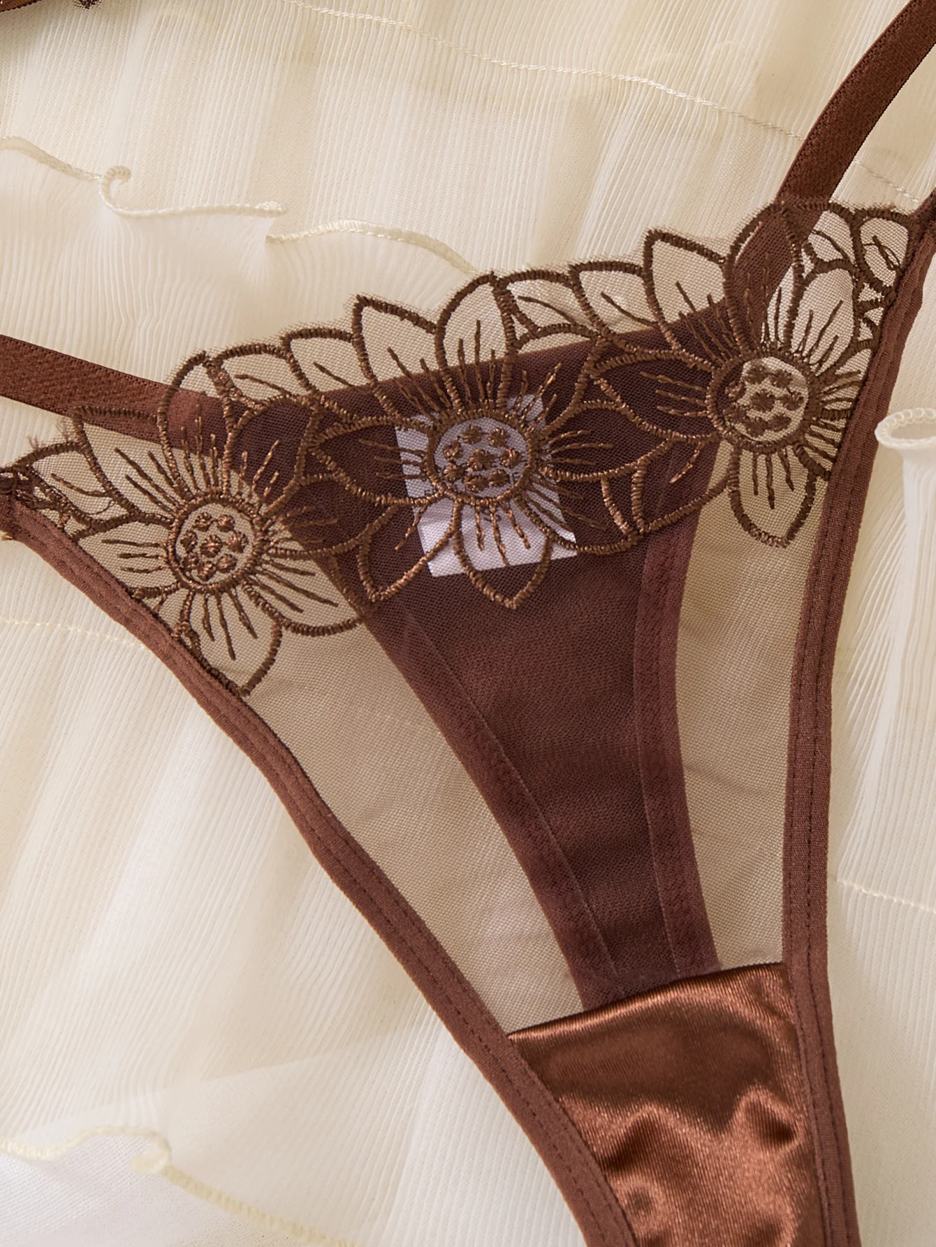Matching thong detail with floral embroidery and slim strap design