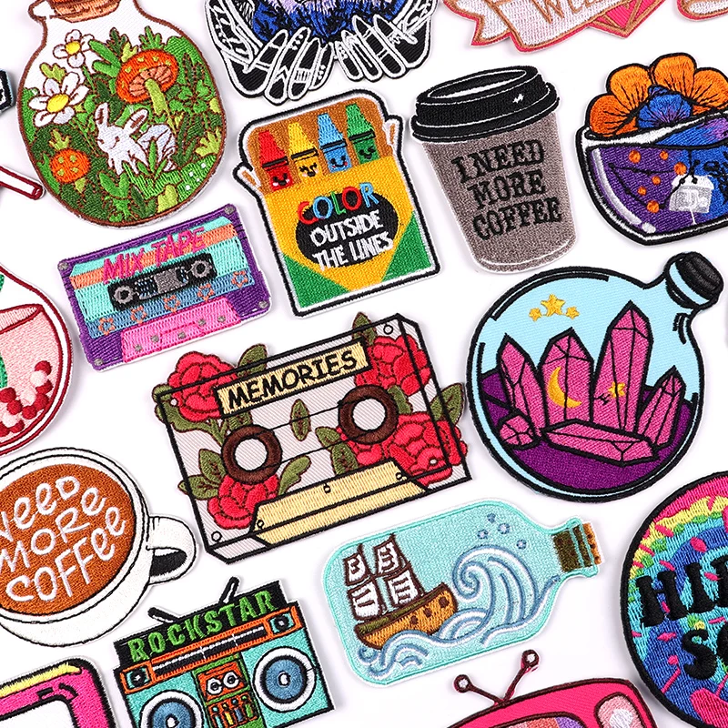Colorful embroidered patches with cassette tapes, coffee cups, motivational quotes, crystals, and bottles