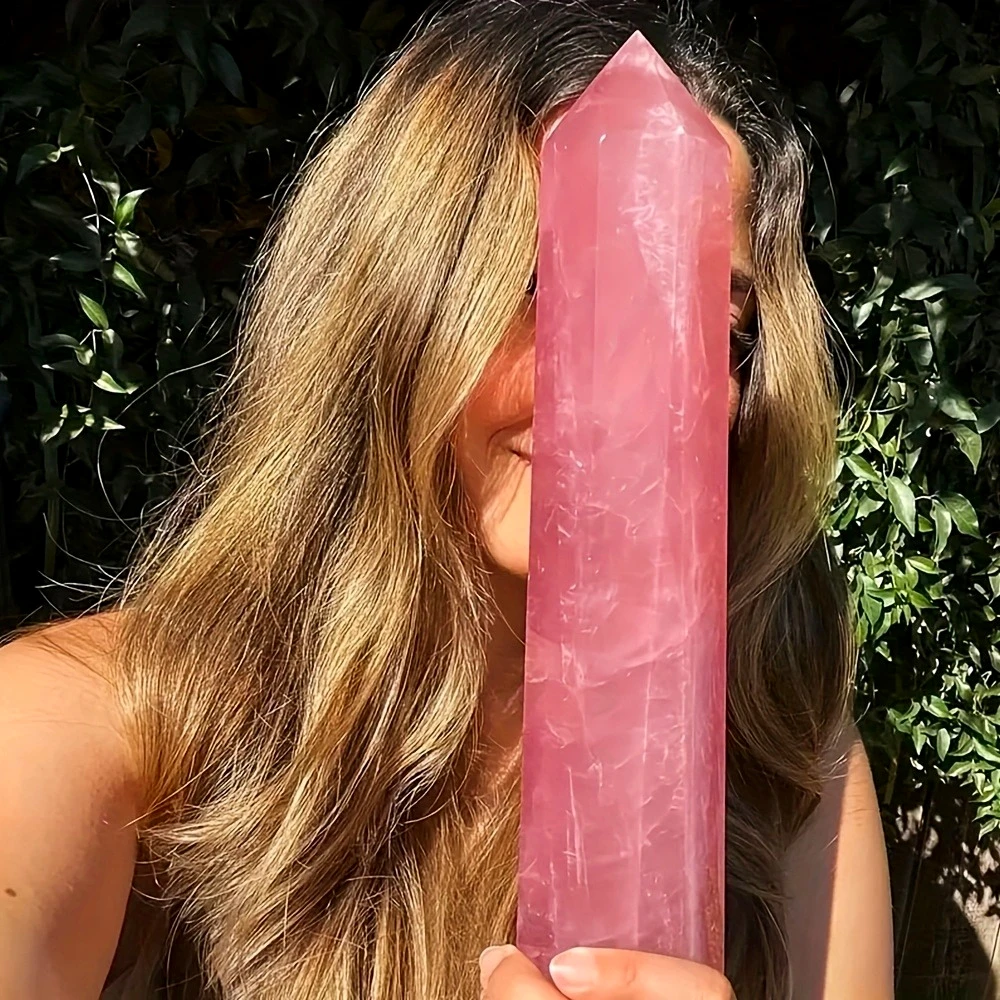 A beautiful, polished Rose Quartz crystal tower, featuring a smooth, six-sided cut and a milky, translucent pale pink hue.