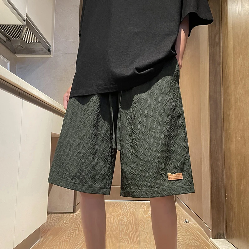 Fashion Solid Color Spliced Pockets Casual Shorts Men's Clothing 2024 Summer New Loose Elastic Lace Up High Waist Knee Shorts