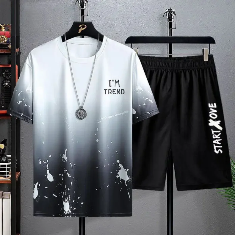 Man relaxing in a modern living room wearing a thin, round-neck T-shirt and matching shorts in a casual summer style white and black