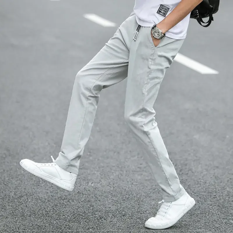 Pantalones casuales blancos rotos de tendencia para hombre, pantalones ajustados de moda para hombre, novedad en ropa de calle holgada, elegante, de algodón con bolsillos anchos