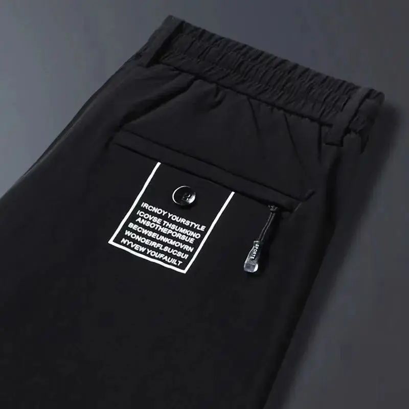 2024 New Summer Men's Ice Shreds Thin Style Trousers Solid Color Elastic Button Zipper Fashionable Loose Casual Harlan Pants