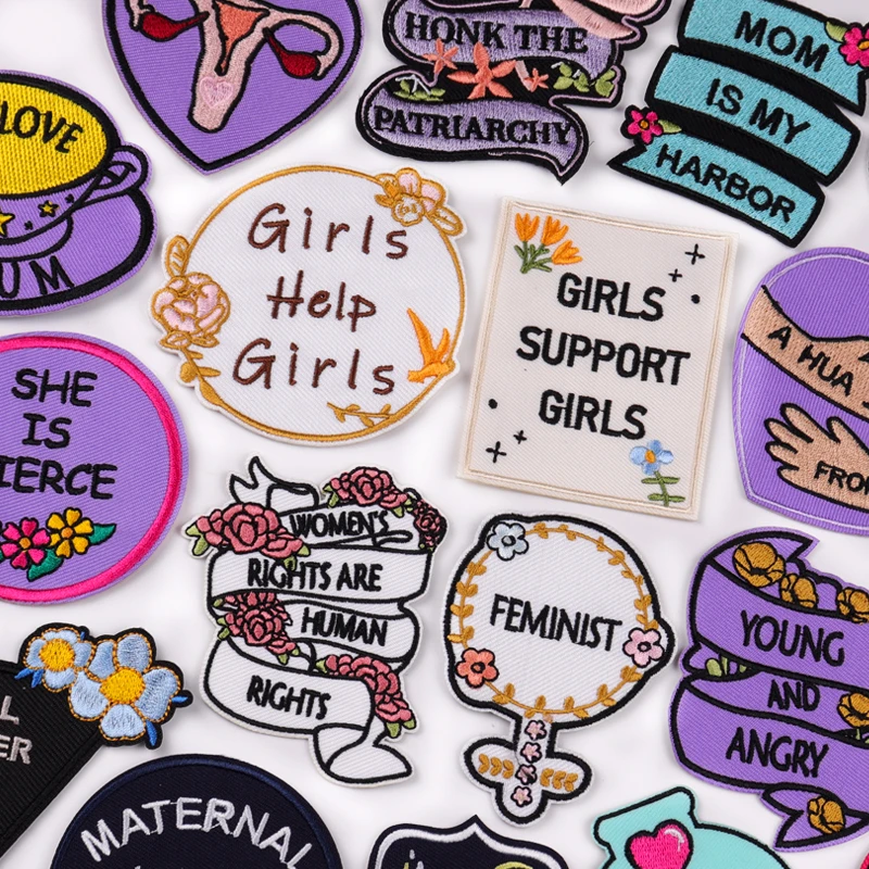 Collection of colorful patches with various messages on a white background
