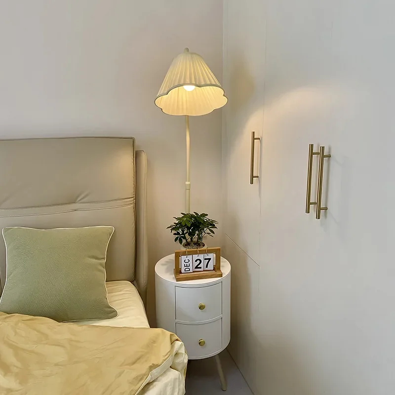 

Living room sofa next to coffee table shelf floor lamp ins cream style bedroom with bedside table drawer integrated light
