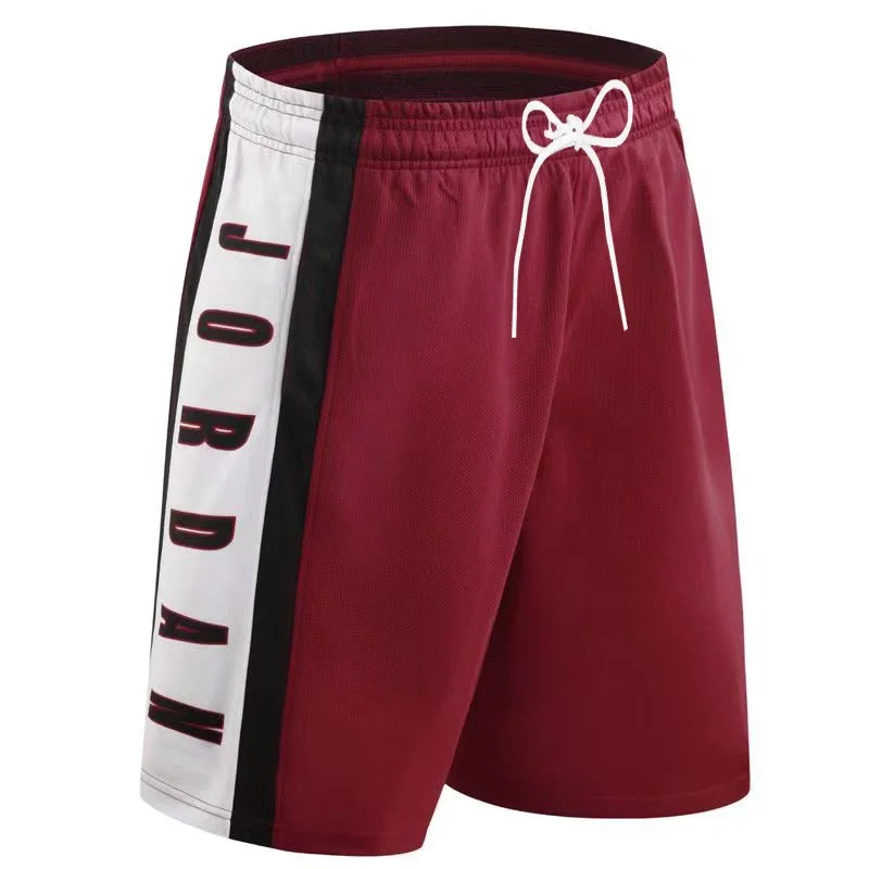 Unisex MOTO beach basketball shorts displayed on model with surfboard and racing helmet, highlighting breathable fabric and sporty design burgendy