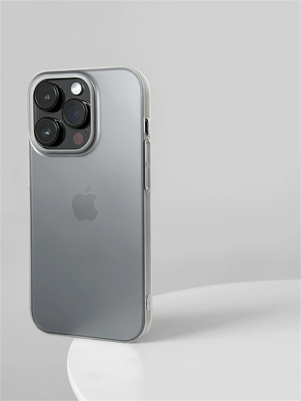 Silver iPhone with Apple logo on a light gray background