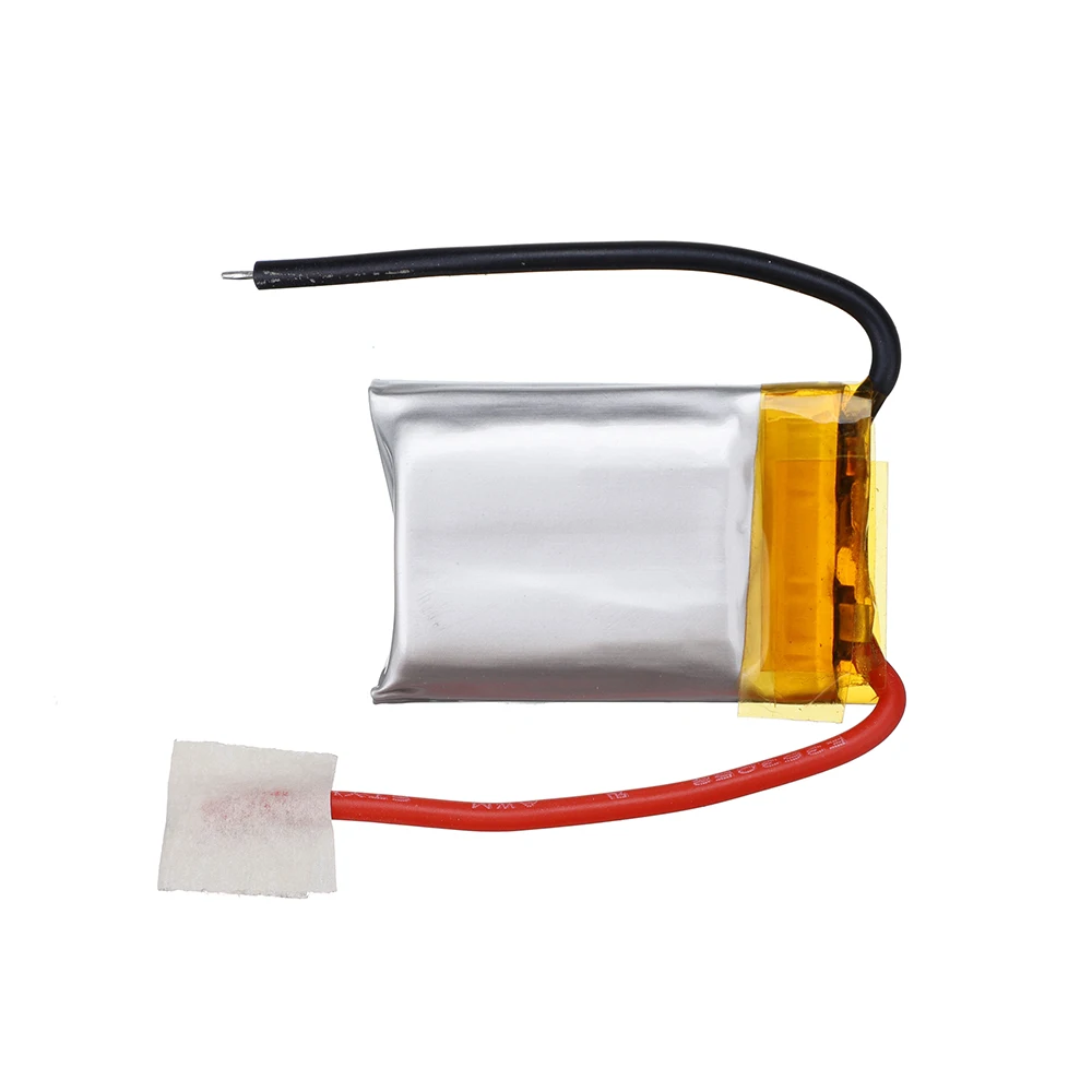 Batterie de rechange pour hélicoptère RC tenue dans une main, montrant sa taille compacte.