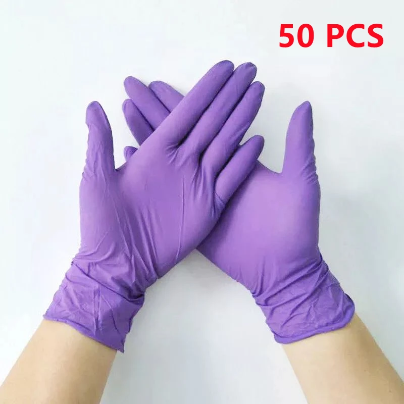 Gants nitrile jetables violets disposés à plat, vue de dessus.