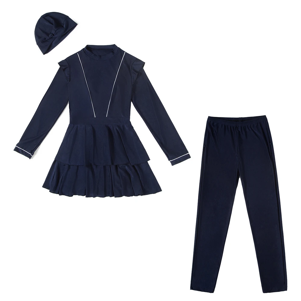 Flat lay of swimwear set in blue showing tunic, skirt, and headscarf
