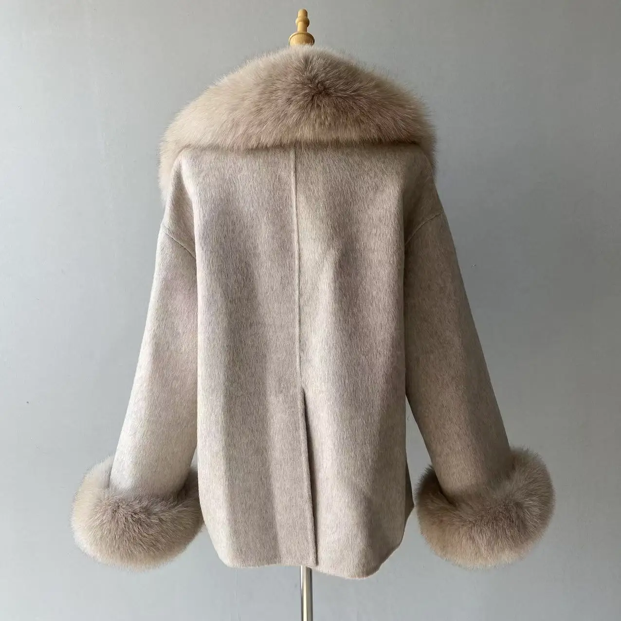 Back view of women's wool coat with fox fur trim