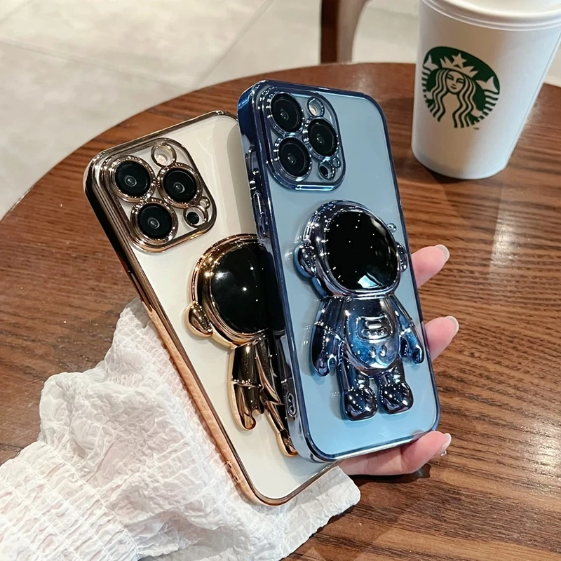 Moda Fold Standing Custodia per telefono trasparente per IPhone 11 12 13 14 15 Pro Mini XS Max XR X Placcatura Astronauta Protegge la copertura_voghion.com