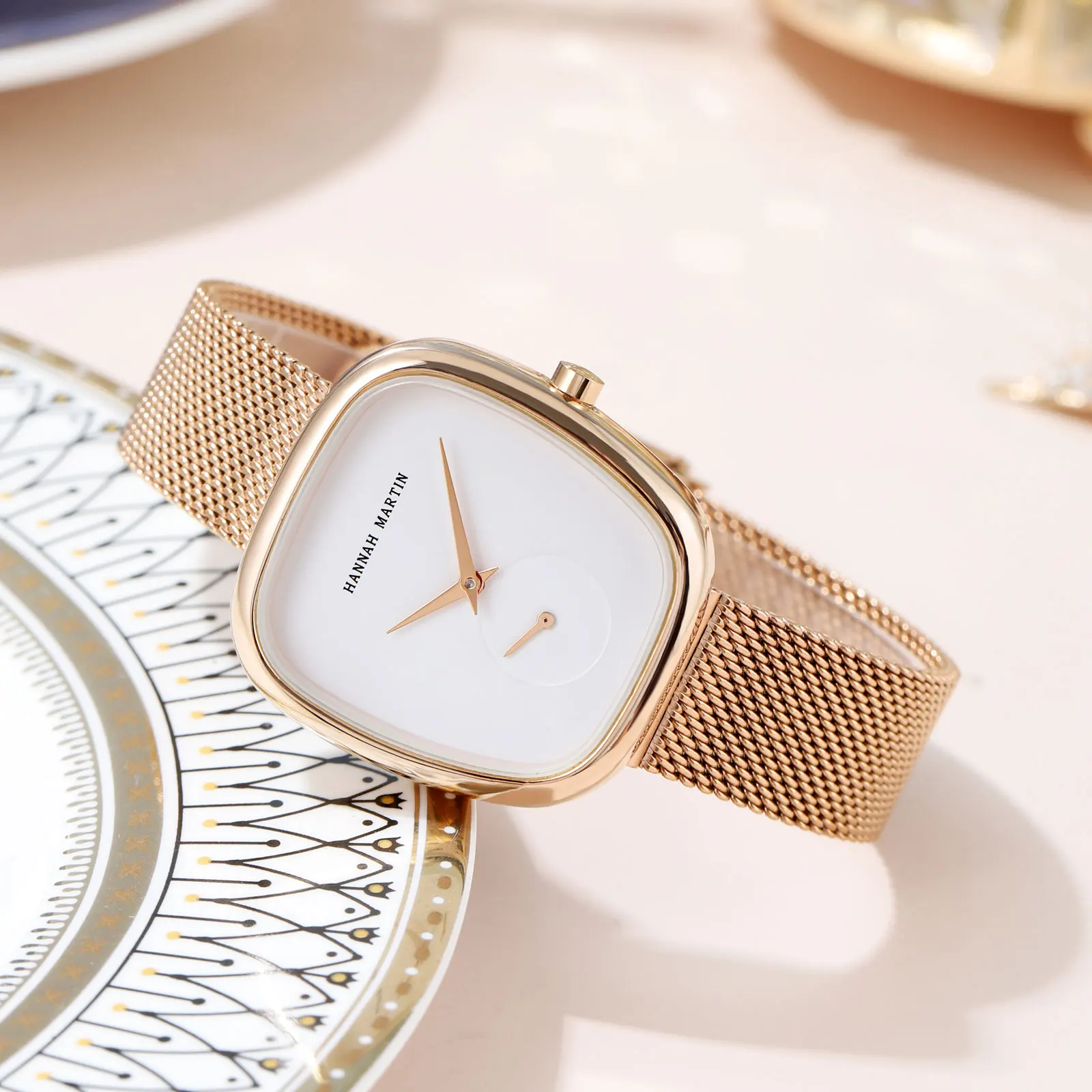 An Elegant Bracelet Wristwatch For Women sitting on a plate.