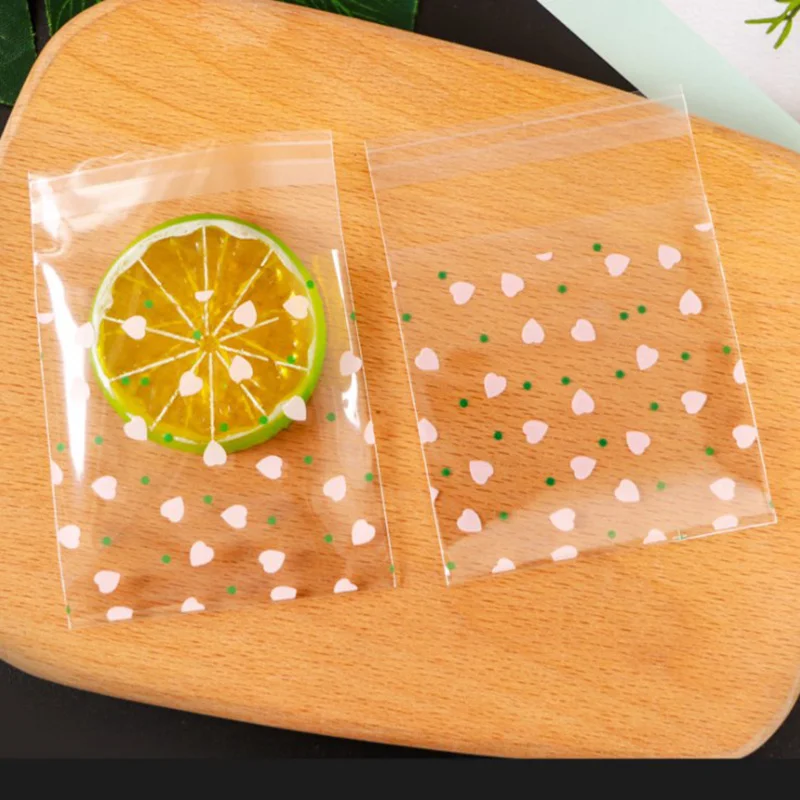 thumbnail image 1 of 100 bolsas de plástico autoadhesivas con forma de flor de cerezo para galletas y dulces, para hacer tú mismo galletas, bocadillos, repostería, decoración, regalos para niños, 1 of 5