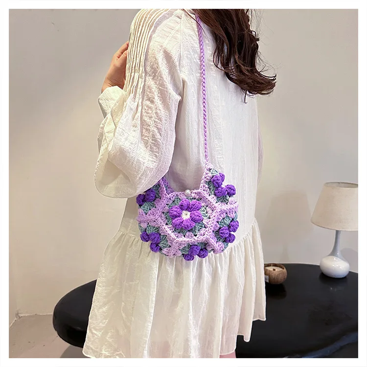 Handmade crescent crochet crossbody bag with soft texture and delicate floral style