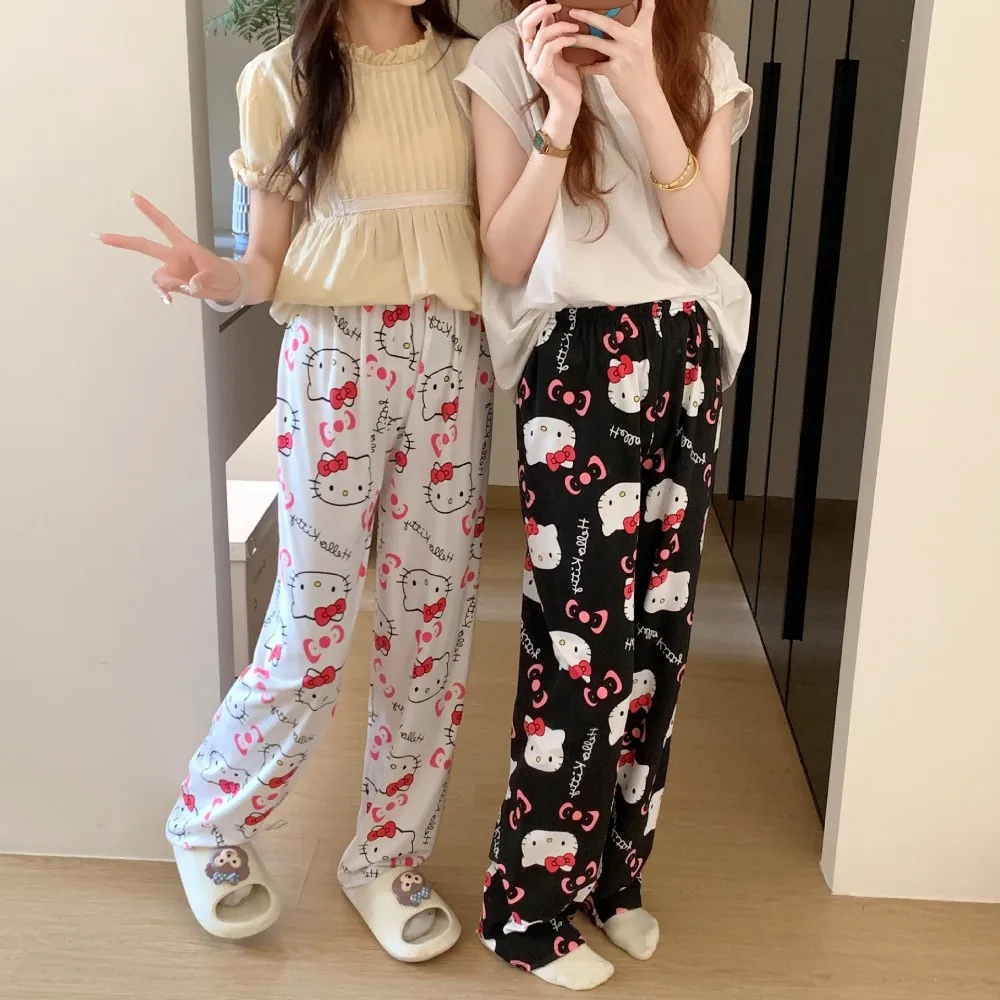 A pair of loose-fitting Hello Kitty pajama pants with a charming cartoon print gray and black