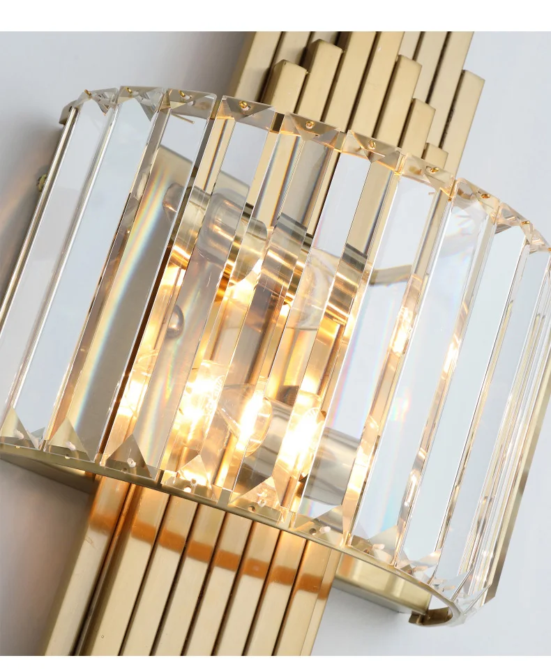 A close-up view of the Luxury Geometric Wall Sconce highlights its design with gold and glass vertical rods and softly glowing lights, elegantly mounted on the wall.