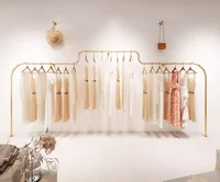 Wall mounted hanging clothes pole on the display rack
