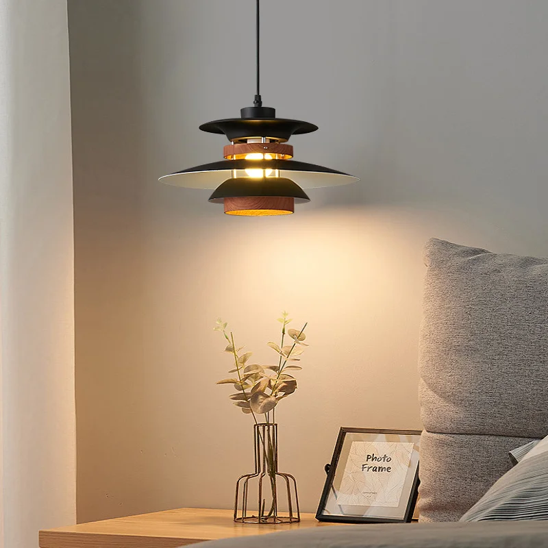 A bedroom with a bed and a pendant light hanging above it, adding a Scandinavian touch to the space.