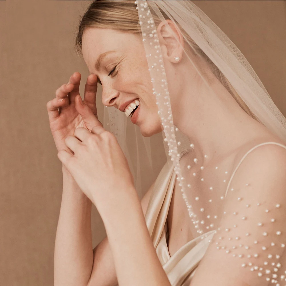 https://ae01.alicdn.com/kf/Se98f72d8c85141d4a4855b95075dfbf3P/NZUK-Bridal-Veil-Bead-Wedding-Veil-Pearls-Wedding-Veils-with-Comb-Type-Layer-Dramatic-1-Tier.jpg