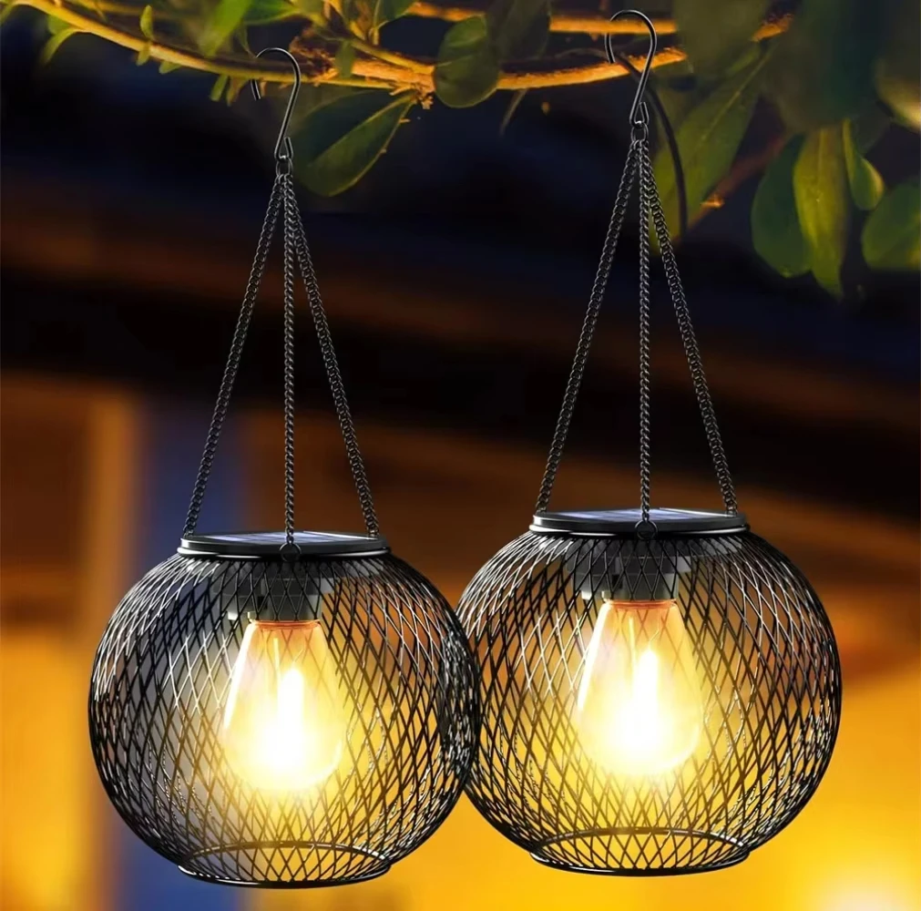 2-pack solar lantaarns close-up — warm gloeiende Edison bulbs
