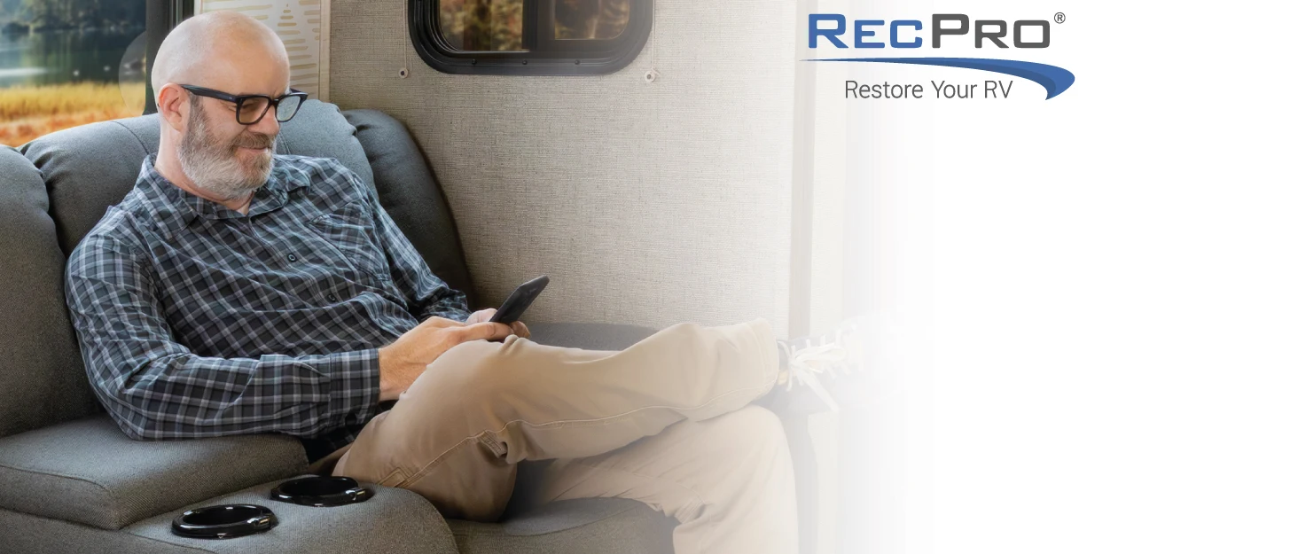 Man smiling and relaxing on RV couch. RecPro: Restore your RV.