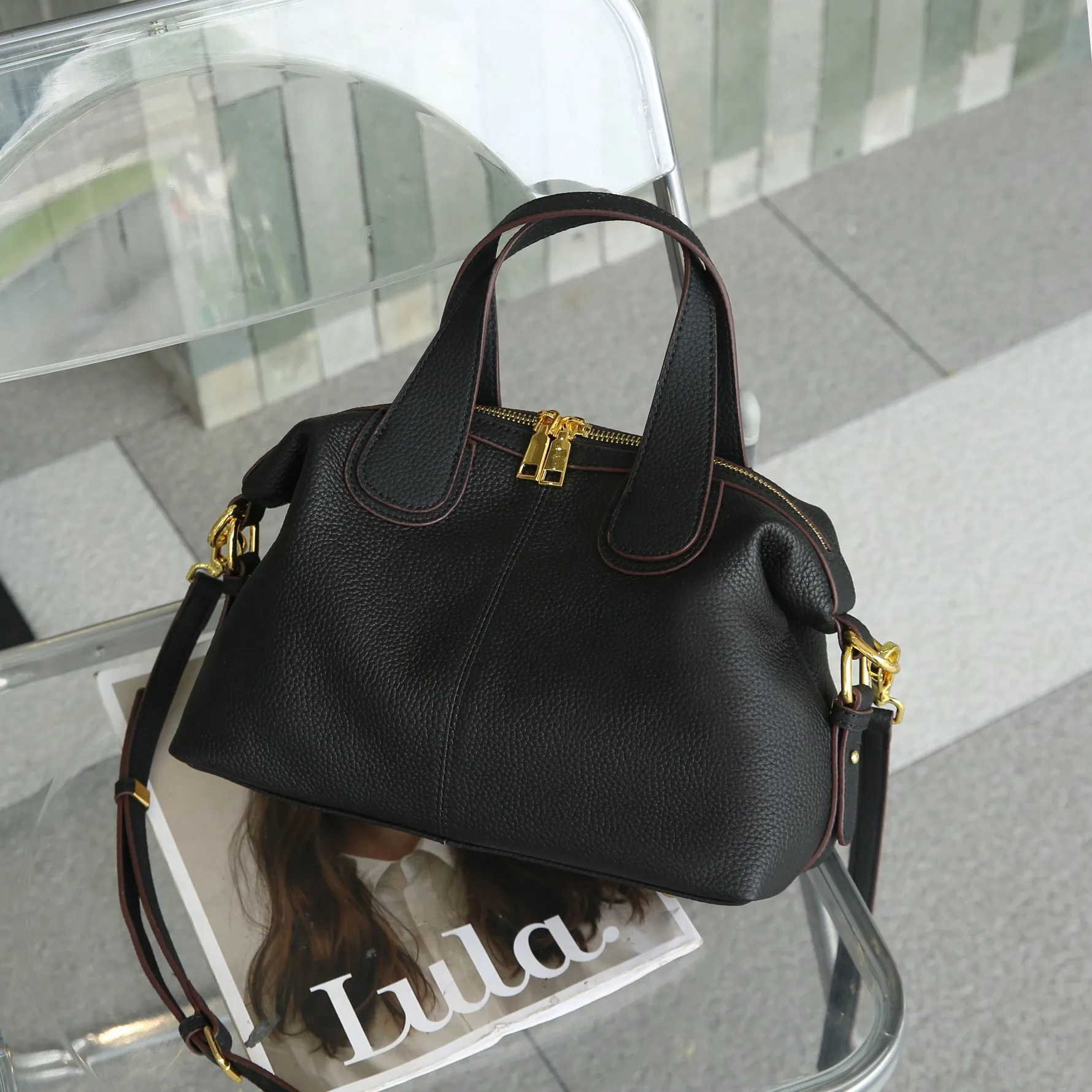 Elegant genuine leather crossbody handbag with shoulder strap and quality details