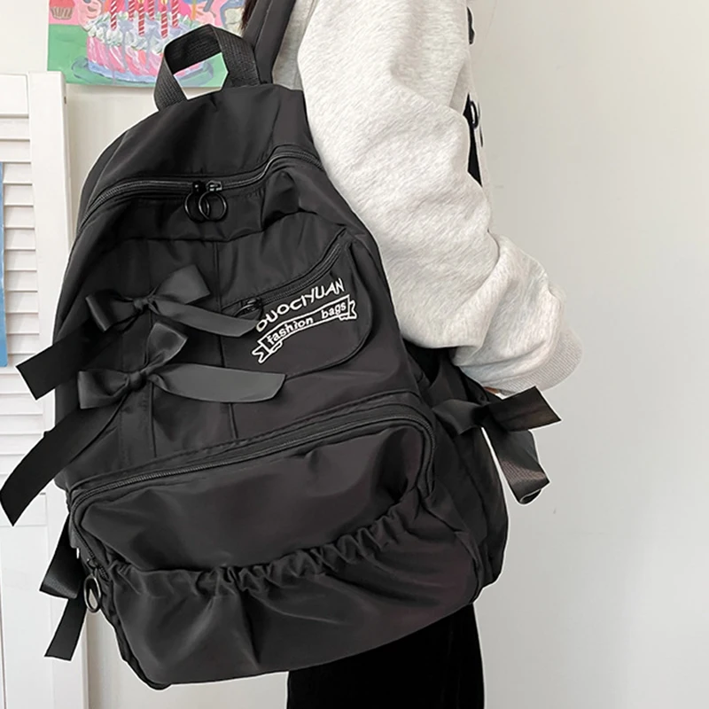 Stylish kawaii backpack with bowknot detail, designed for women and girls, featuring soft pastel tones and spacious compartments for school essentials.black