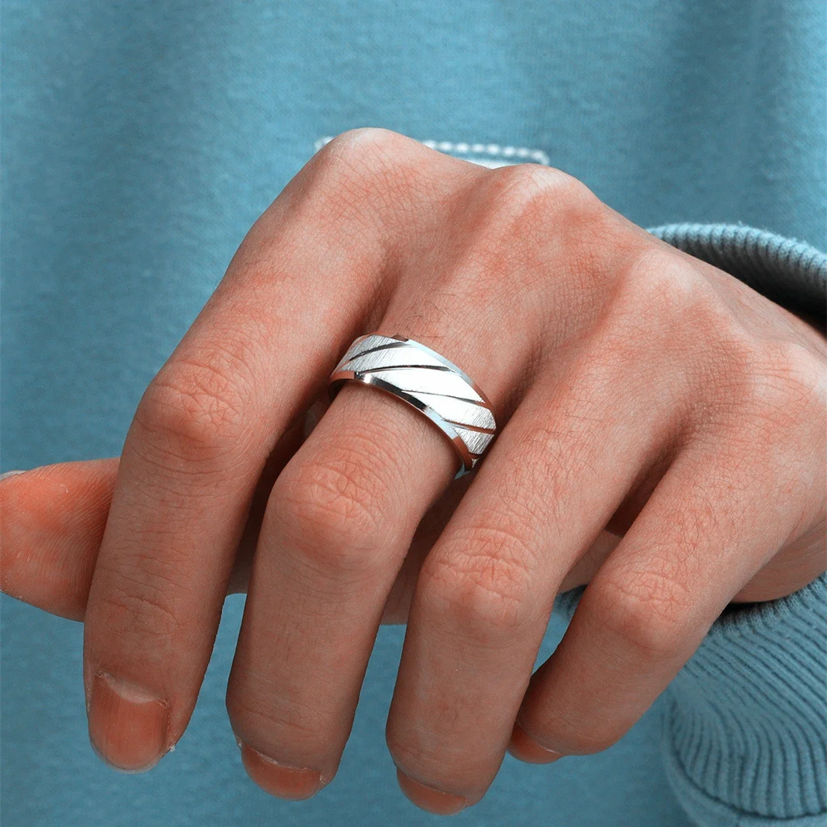 Unisex stainless steel wedding bands with unique wave texture for couples.