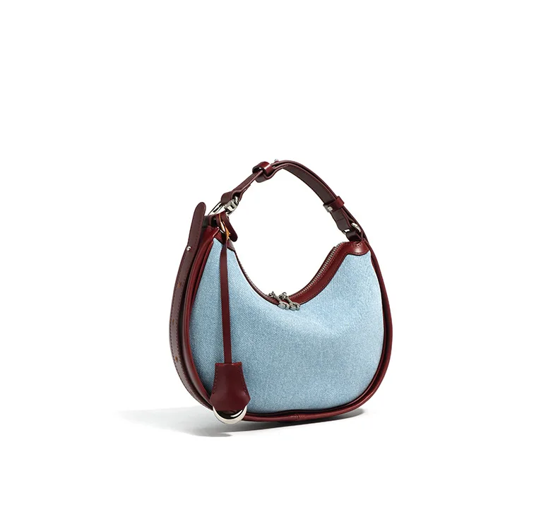 Half moon shoulder bag made of denim with genuine leather trim – casual and stylish design for daily use.